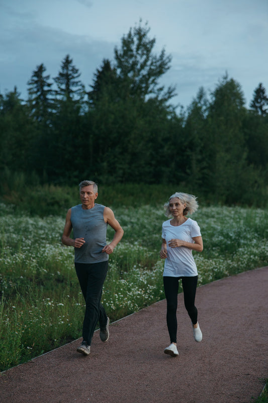 an elderly man and women jogging